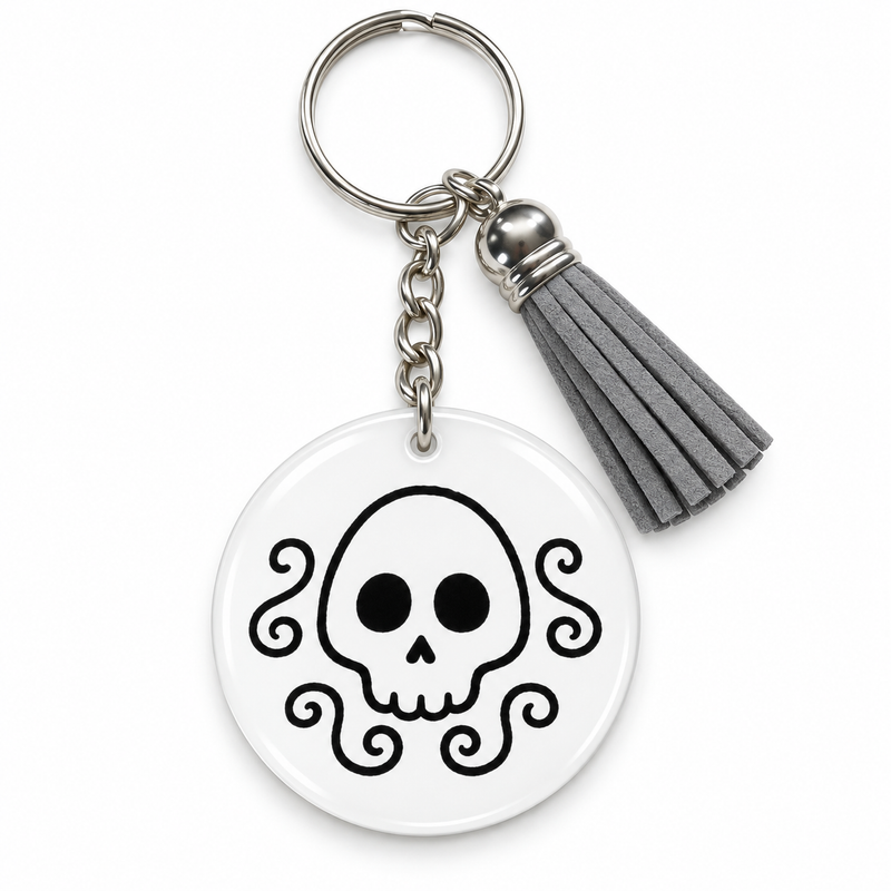 Porte-clés Halloween blanc motif tête de mort noire entourée d'arabesques, pompon gris – EDISAMP