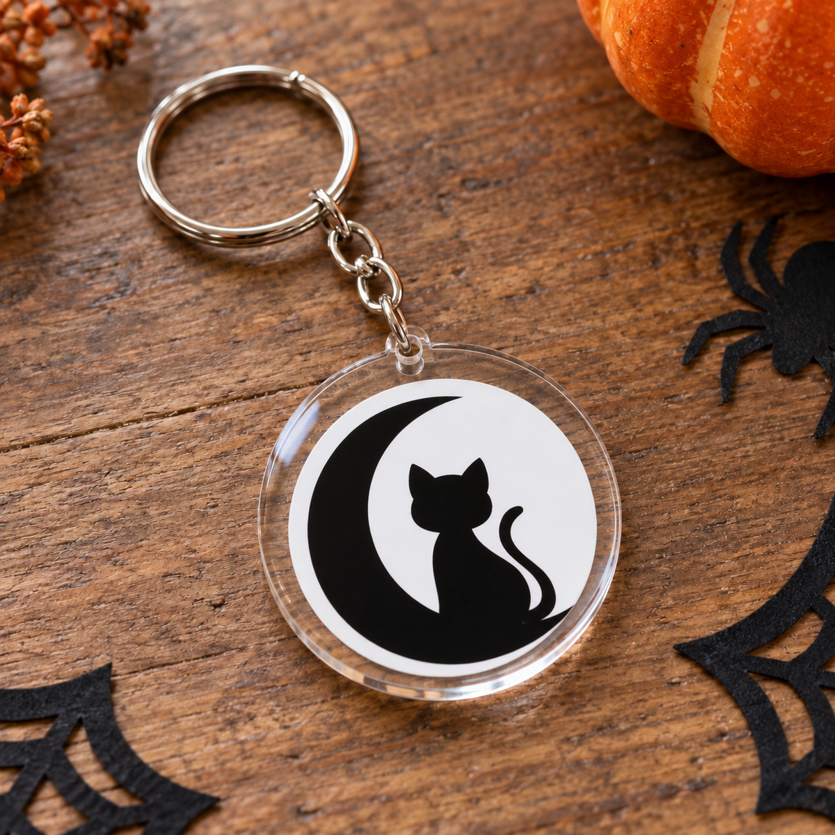 Porte-clés Halloween rond en acrylique chat noir assis dans un croissant de lune