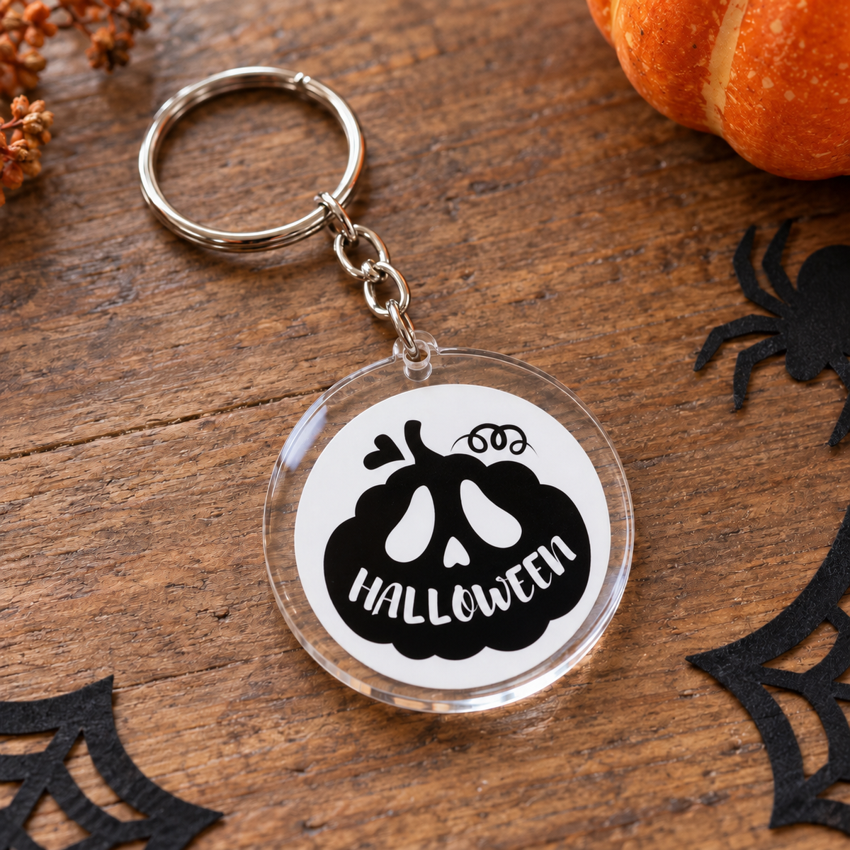 Porte-clés Halloween rond en acrylique citrouille noire avec le mot Halloween